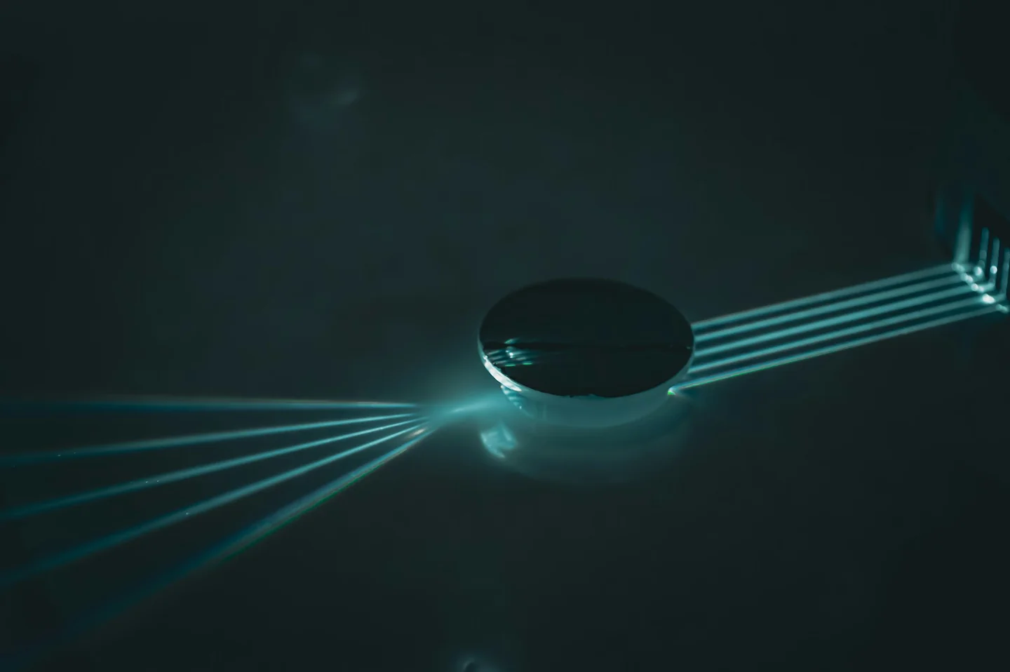 Colored light refracting through a glass optical element.